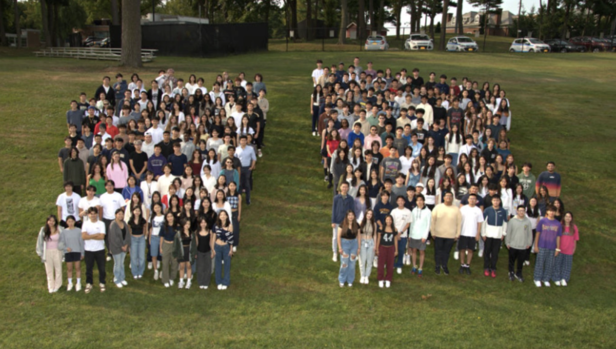 Standing Together—The entire senior class stands for a group photo, forming two equally sized clusters. The photo—a senior tradition—represents our class solidarity, as it was taken at the beginning of the end of our final year together, demonstrating our community commitment. 
